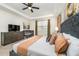 Spacious bedroom with a crib, stylish furniture, and a calming color palette at 1781 Sawyer Palm Pl, Kissimmee, FL 34747