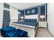 Cozy main bedroom with a blue and white color scheme and modern decor at 1781 Sawyer Palm Pl, Kissimmee, FL 34747
