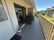 Exterior balcony space showing the sliding door, safety rails, and a view of the surrounding community at 1935 Conway Rd # T6, Orlando, FL 32812