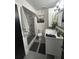 Modern bathroom featuring a vanity with sink, shower with black and white tile, and neutral walls and flooring at 1935 Conway Rd # T6, Orlando, FL 32812