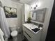 Updated bathroom features a modern vanity, decorative mirror, and stylish fixtures creating a serene and functional space at 1935 Conway Rd # T6, Orlando, FL 32812