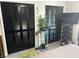 Bedroom with black closet doors, modern decor, and a television mounted on the wall at 1935 Conway Rd # T6, Orlando, FL 32812