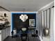 Modern dining room featuring a glass table, unique lighting fixture and black brick accent wall with blue lighting at 1935 Conway Rd # T6, Orlando, FL 32812