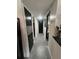 Modern hallway with black doors, white walls, and a skylight providing natural light at 1935 Conway Rd # T6, Orlando, FL 32812