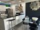 Stylish kitchen blends seamlessly into dining area, featuring black countertops and floating shelves for decor at 1935 Conway Rd # T6, Orlando, FL 32812
