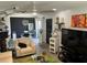 Bright living room featuring white furniture, black accents, modern lighting, and an adjacent dining area at 1935 Conway Rd # T6, Orlando, FL 32812