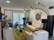 Open living room with white furniture, a green rug, unique lighting, and minimalist decor at 1935 Conway Rd # T6, Orlando, FL 32812
