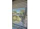 Scenic view from a window showcasing lush landscaping, a glimpse of a serene lake, and nearby residential buildings at 1935 Conway Rd # T6, Orlando, FL 32812