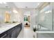 Modern bathroom with double vanity, granite countertops, and a glass-enclosed shower at 1938 Spring Shower Cir, Kissimmee, FL 34744