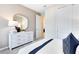 Well-lit bedroom showcasing a white dresser, decorative mirror, and neutral decor at 1938 Spring Shower Cir, Kissimmee, FL 34744