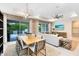 Open concept dining area with a modern table set, views to the outdoor patio, and adjacent to living room at 1938 Spring Shower Cir, Kissimmee, FL 34744