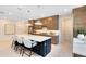 Contemporary kitchen featuring a large island with seating, modern lighting, and ample cabinet storage at 1938 Spring Shower Cir, Kissimmee, FL 34744