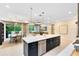 Bright kitchen with a large island, stainless steel appliances, and open floor plan to living and dining areas at 1938 Spring Shower Cir, Kissimmee, FL 34744