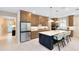 Modern kitchen with stainless steel appliances, a spacious island, and ample cabinet space at 1938 Spring Shower Cir, Kissimmee, FL 34744