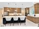 Well-equipped kitchen featuring stainless steel appliances, a large island, and stylish bar stools at 1938 Spring Shower Cir, Kissimmee, FL 34744