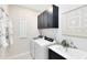 Functional laundry room with modern appliances, built-in cabinets, and a sink at 1938 Spring Shower Cir, Kissimmee, FL 34744