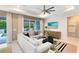 Cozy living room with modern furnishings, large windows with lush views, and a stylish entertainment center at 1938 Spring Shower Cir, Kissimmee, FL 34744