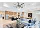 Open-concept living space with contemporary design, featuring a large ceiling fan, modern furniture, and a gourmet kitchen at 1938 Spring Shower Cir, Kissimmee, FL 34744