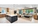 Open-concept living space with kitchen island, dining area, and cozy living room at 1938 Spring Shower Cir, Kissimmee, FL 34744
