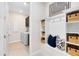 Mudroom with built-in storage, a bench, and modern decor, and laundry area at 1938 Spring Shower Cir, Kissimmee, FL 34744