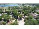 Aerial view of the neighborhood with nearby lake surrounded by mature trees at 2082 Nexus Ct, Apopka, FL 32712