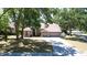 Aesthetic shot of a cozy single-story home featuring three-car garage, lush lawn, and nearby neighborhood at 2082 Nexus Ct, Apopka, FL 32712