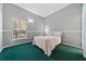 Serene bedroom with a large window, neutral walls, and plush green carpet at 2082 Nexus Ct, Apopka, FL 32712