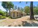Beautiful home featuring large windows, manicured landscaping, and a tranquil setting among mature trees at 2082 Nexus Ct, Apopka, FL 32712