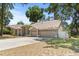 Traditional home with three-car garage, well-maintained lawn, and a welcoming front entrance at 2082 Nexus Ct, Apopka, FL 32712