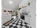 Clean kitchen featuring checkerboard floors, all-white cabinets, and modern appliances at 2082 Nexus Ct, Apopka, FL 32712