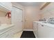Functional laundry room equipped with sink, washer, dryer, storage, and easy access to the rest of the home at 2082 Nexus Ct, Apopka, FL 32712