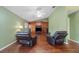 Relaxing living room with wood floors, comfortable recliners, and a built-in entertainment center at 2082 Nexus Ct, Apopka, FL 32712