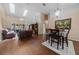 Bright, open-concept living and dining room with hardwood floors, natural light, and stylish furnishings at 2082 Nexus Ct, Apopka, FL 32712