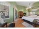 Bright main bedroom with vaulted ceiling, wood floors, sliding glass doors, and classic furniture at 2082 Nexus Ct, Apopka, FL 32712