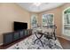 Sunlit office featuring arched windows, ceiling fan, modern workstation, and stylish decor at 2082 Nexus Ct, Apopka, FL 32712
