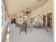 Enclosed outdoor patio featuring comfortable wicker furniture and a swing at 2082 Nexus Ct, Apopka, FL 32712