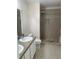 Bathroom featuring double sinks and a tiled walk-in shower is designed for modern comfort at 2164 Black Mangrove Dr, Orlando, FL 32828