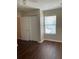 Bedroom features a window with blinds, a ceiling fan, and wood-look flooring at 2164 Black Mangrove Dr, Orlando, FL 32828