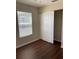 Bedroom with wood-look flooring, a closet, and a window with blinds at 2164 Black Mangrove Dr, Orlando, FL 32828