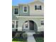 Charming two-story home with an arched entrance and well-maintained landscaping at 2164 Black Mangrove Dr, Orlando, FL 32828