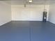 Garage featuring painted flooring, a water heater, and a white door at 2164 Black Mangrove Dr, Orlando, FL 32828
