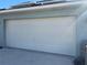Garage featuring a white panel door on a home with light blue siding at 2164 Black Mangrove Dr, Orlando, FL 32828