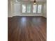 Inviting living room featuring hardwood flooring, neutral walls, and multiple windows for natural light at 2164 Black Mangrove Dr, Orlando, FL 32828
