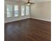 Bright living room with hardwood flooring, multiple windows, and a ceiling fan at 2164 Black Mangrove Dr, Orlando, FL 32828