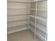 Spacious walk-in pantry with tiled flooring and white wire shelving units at 2164 Black Mangrove Dr, Orlando, FL 32828