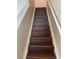 Staircase with wood stairs and white risers provides access to the upper level of the home at 2164 Black Mangrove Dr, Orlando, FL 32828