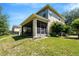 Rear exterior showing a screened lanai and a well-maintained lawn at 2401 Home Again Rd, Apopka, FL 32712