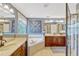 Beautiful primary bath featuring a soaking tub, dual vanities, and separate glass enclosed shower at 2401 Home Again Rd, Apopka, FL 32712