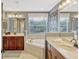 Primary bathroom with dual sink vanity, soaking tub under window, and large framed mirror at 2401 Home Again Rd, Apopka, FL 32712