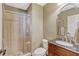Neutral-toned bathroom features a tile shower with glass door and a dark wood vanity at 2401 Home Again Rd, Apopka, FL 32712